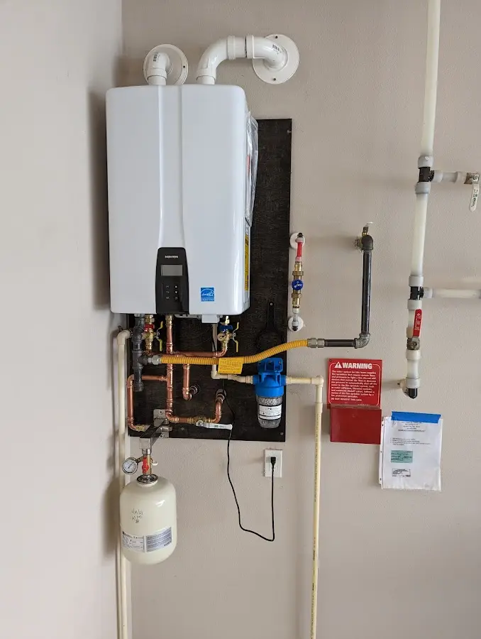 Professional plumber installing copper piping in a Alice home